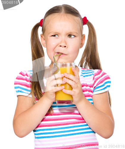 Image of Little girl unwillingly drinking orange juice