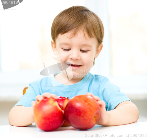 Image of Portrait of a happy little boy with apples