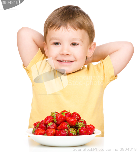 Image of Happy little boy with strawberries