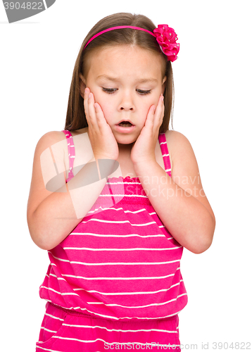 Image of Little girl is holding her face in astonishment