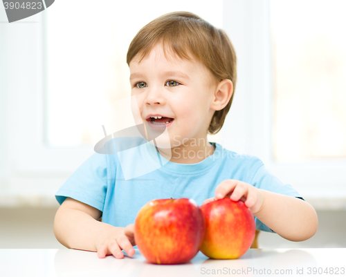 Image of Portrait of a happy little boy with apples