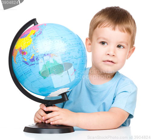 Image of Happy little boy with a globe