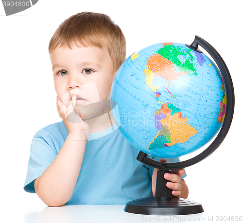 Image of Little boy with a globe