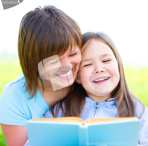 Image of Mother is reading book with her daughter