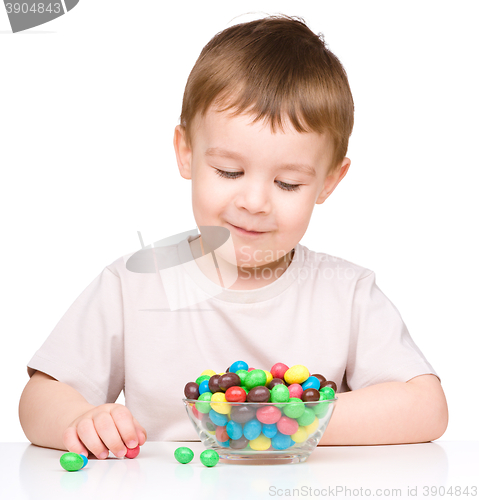 Image of Portrait of a boy with candies