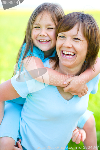 Image of Portrait of a happy mother with her daughter