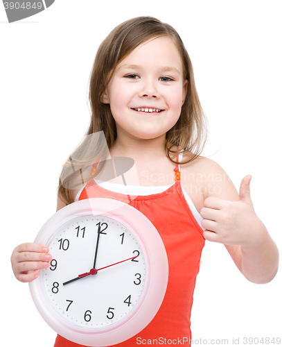 Image of Little girl is holding big clock