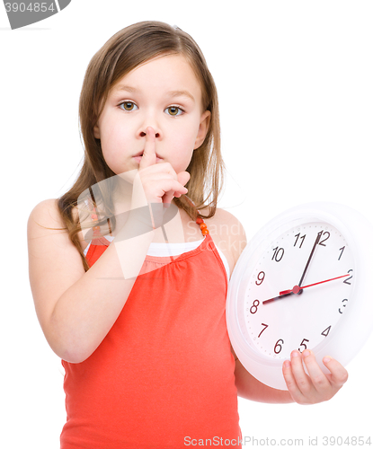 Image of Little girl is holding big clock