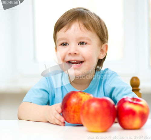 Image of Portrait of a happy little boy with apples