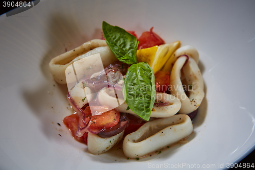 Image of healthy rings squid salad with tomatoes