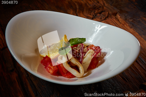 Image of healthy rings squid salad with tomatoes