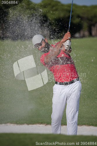 Image of golfer hitting a sand bunker shot