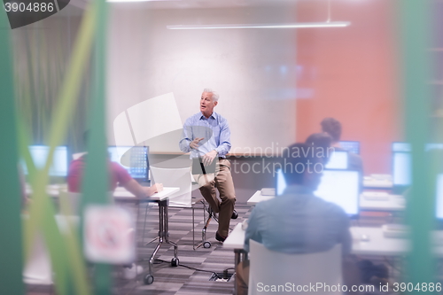 Image of teacher and students in computer lab classroom