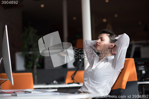 Image of happy young business woman relaxing and geting insiration