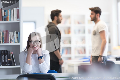 Image of female student study in school library, group of students in bac