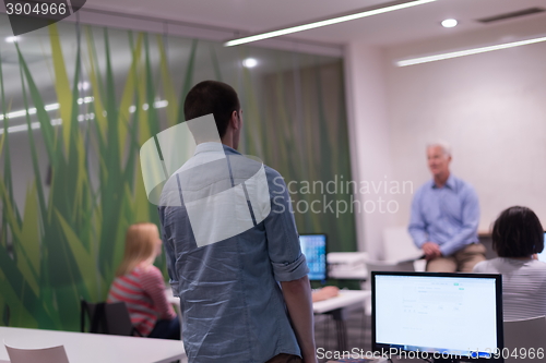 Image of student answering a question in classroom