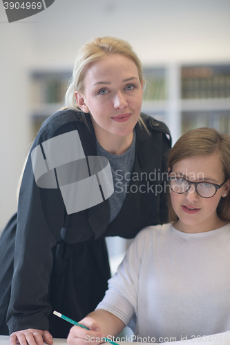 Image of female teacher helping students on class