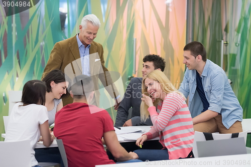 Image of teacher with a group of students in classroom