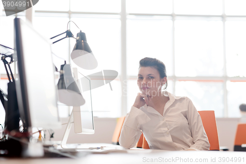 Image of business woman working on computer at office