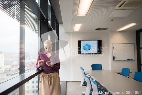 Image of young business woman using smart phone