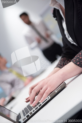 Image of woman hands typing on laptop keyboard at business meeting