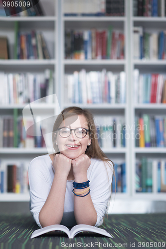 Image of female student study in library, using tablet and searching for 