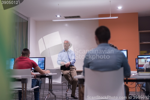Image of teacher and students in computer lab classroom