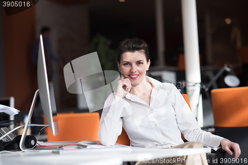 Image of happy young business woman relaxing and geting insiration