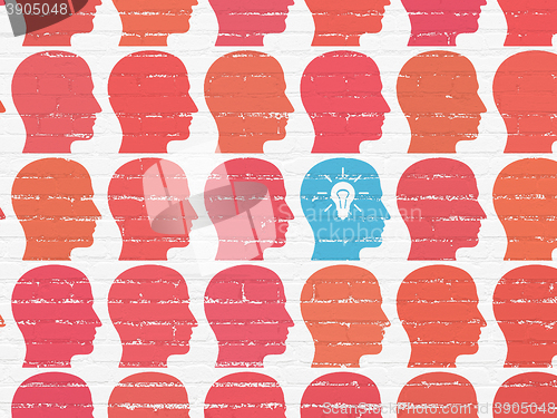 Image of Business concept: head with light bulb icon on wall background