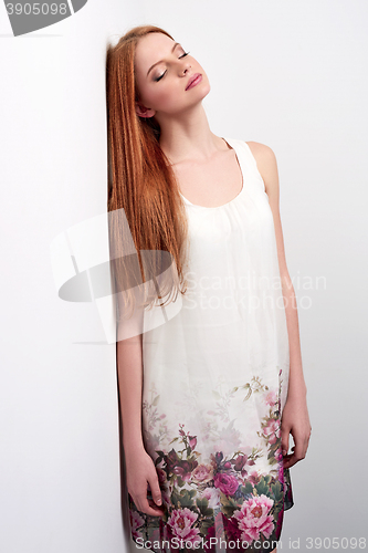 Image of Beautiful female in sleeveless flower print summer dress 