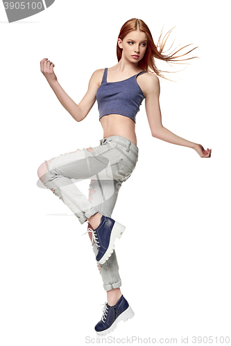 Image of Hip-hop style teenage girl jumping dancing