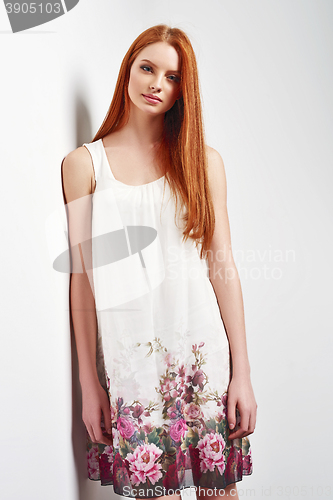 Image of Beautiful female in sleeveless flower print summer dress 