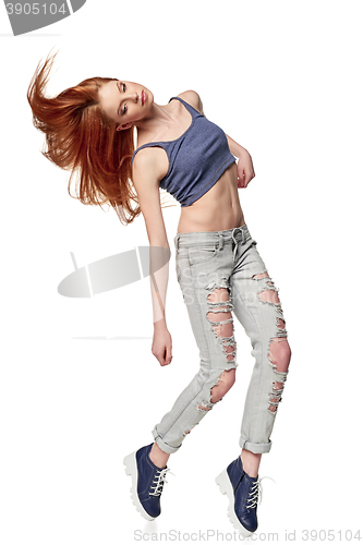 Image of Hip-hop style teenage girl jumping dancing