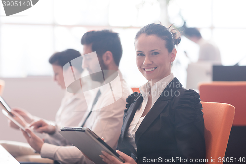 Image of business woman on meeting  using tablet