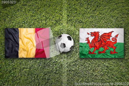 Image of Belgium vs. Wales flags on soccer field