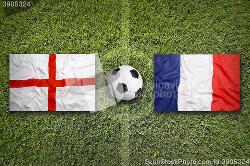 Image of England vs. France flags on soccer field