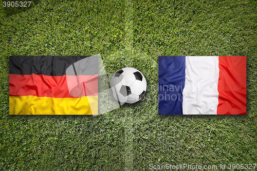 Image of Germany vs. France flags on soccer field