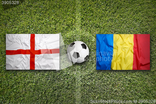 Image of England vs. Romania flags on soccer field