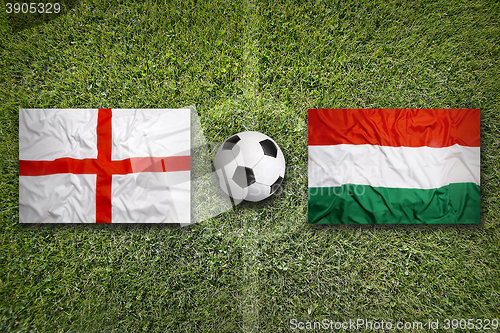 Image of England vs. Hungary flags on soccer field