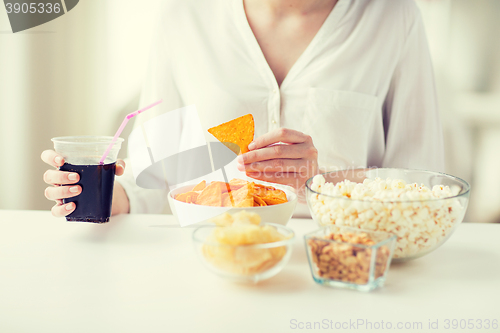 Image of close up of woman with junk food and coca cola cup