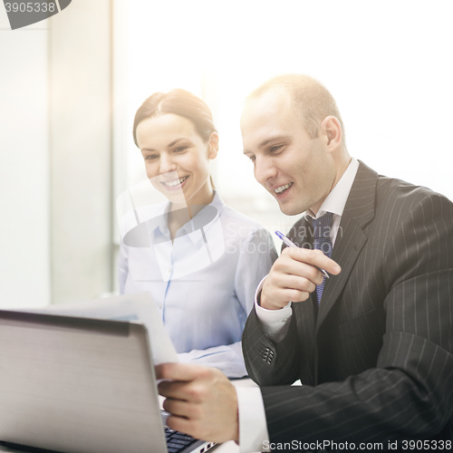 Image of businessman and businesswoman having discussion