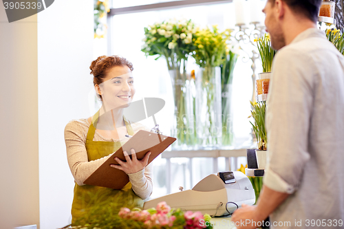 Image of florist woman and man making order at flower shop