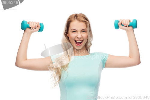 Image of smiling beautiful young sporty woman with dumbbell