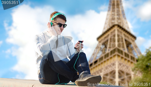 Image of happy young man in headphones with smartphone