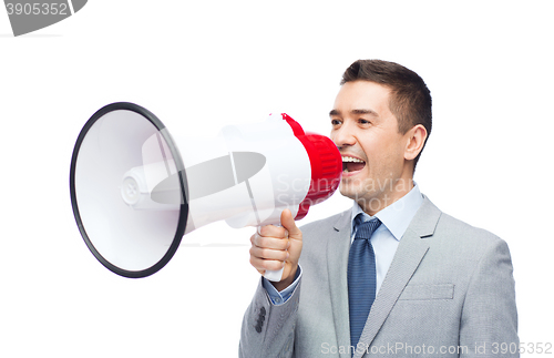 Image of happy businessman in suit speaking to megaphone