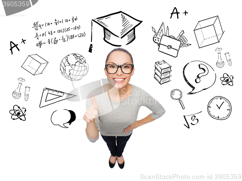 Image of happy woman showing thumbs up over school doodles