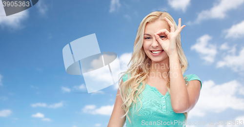 Image of young woman making ok hand gesture