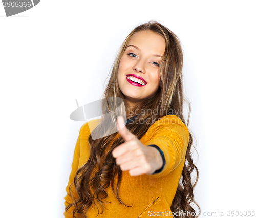 Image of happy young woman or teen girl showing thumbs up