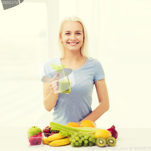 Image of smiling woman drinking juice or shake at home