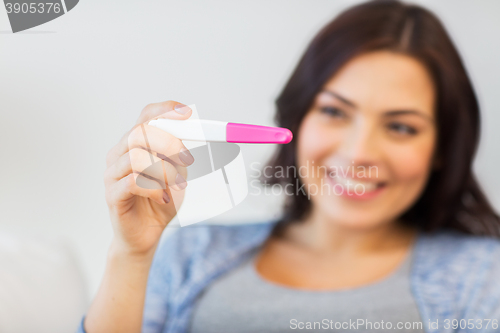 Image of close up of happy woman with home pregnancy test